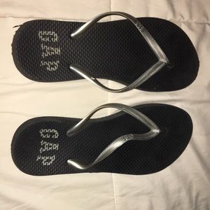 Black and grey gap flip flops